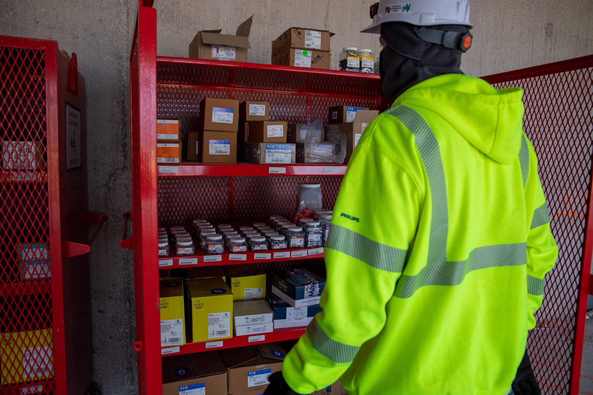 Mars Electric employee replenishing stock at a customer jobsite