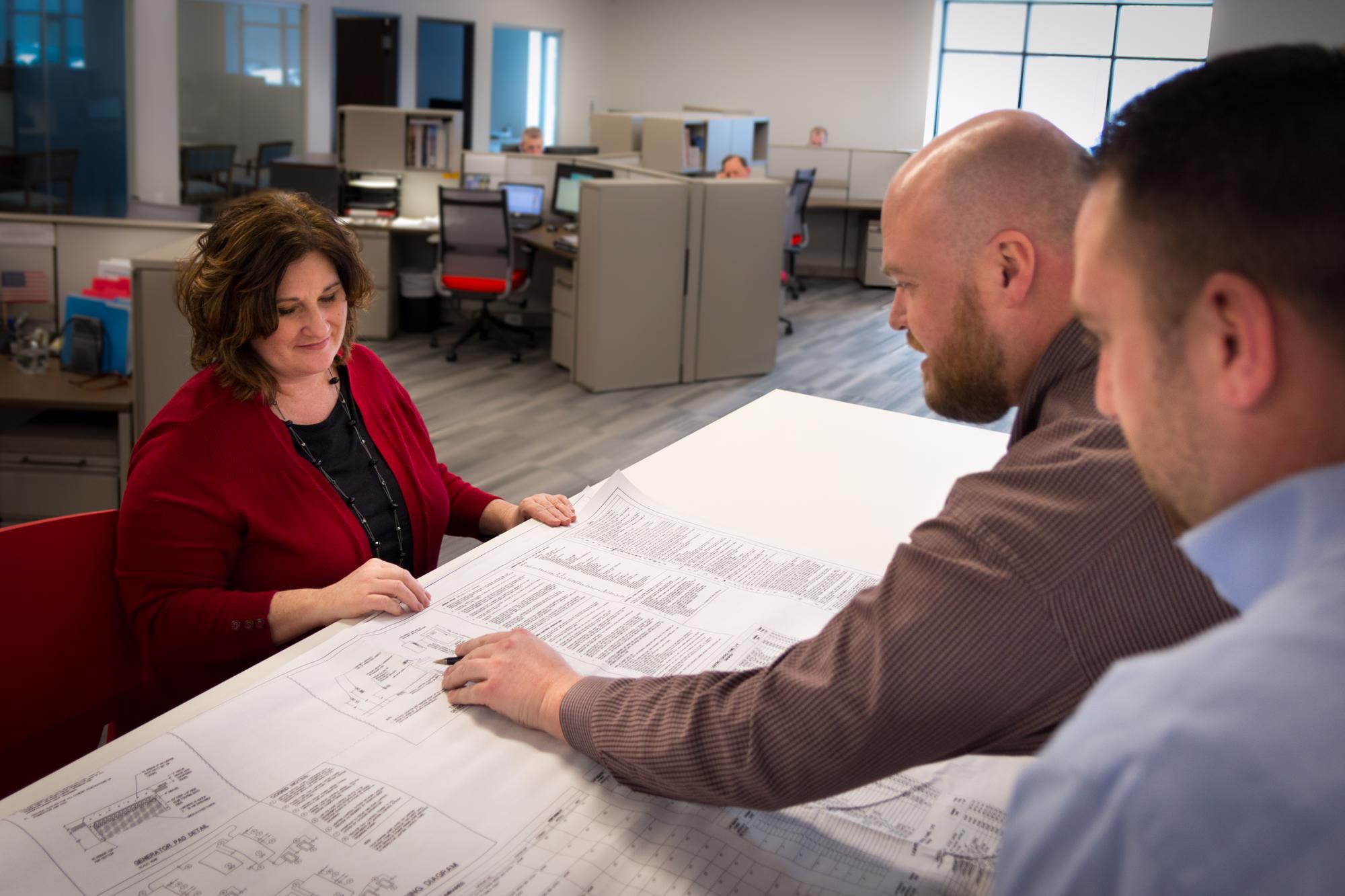 Mars Employees discussing jobsite lighting blueprints